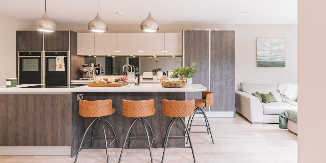 Open plan brown and cream kitchen