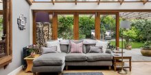 Quay View Interior Design Living room with open bifold doors